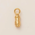 Detailed close-up of a polished gold 18K stainless steel pendant with FC engravings - Bullet Style