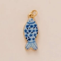 Detailed macro of a gold-plated fish pendant with blue enamel flower patterns - Small Fish Pendant (YKBS26032007GK)
