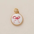 Macro detail of golden circular pendant with pink watercolor bow on white enamel - Bowknot Pendant