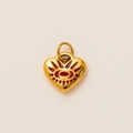Detailed macro view of a gold heart charm pendant with a red enamel eye motif - True Love Heart Pendant No. 2