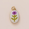 Macro detail of oval pendant with purple floral ceramic inlay and 18K gold plating - White Small Green Flower Pendant