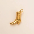 Dettaglio ravvicinato di un ciondolo a stivale da cowboy in acciaio inossidabile placcato oro 18K - Stile Stivali Dorati