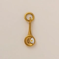 Macro shot of a creative 18K gold plated fried egg frying pan pendant for DIY jewelry - Fried Egg in Pan