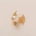 Detailed macro view of a 18K gold fish pendant with a round white pearl and zircon eye - No 12 Pearl Fish Pendant
