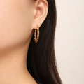 Chic golden twisted hoop earrings with a metallic spiral design on a female model - Twisted Rope Style (F1415) / Gold