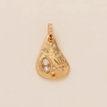 Detail of gold teardrop pendant with starburst engraving and colorful crystal inlay - Irregular Star Burst