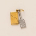 Detailed macro view of gold rectangle and silver grater charms on stainless steel rings - Letter