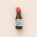 Detail of 18K gold-plated Pinot Noir wine bottle pendant with pink seal and black finish - Wine Bottle / Black