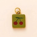 Detail van een vintage kersen hanger met groene textuur en 18K gouden metalen ringen - Groene Kers Hanger