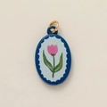 Detailed close-up of oval tulip pendant with blue border and pink flower on beige background - Pink Tulip-Oval