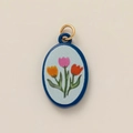 Detail of oval enamel tulip pendant with blue base and golden metal loop ring - Three Colorful Tulips Style