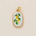 Detailed close-up of oval lemon pendant with yellow metal frame and blue striped background - Lemon White Flower Pendant
