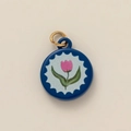 Close-up of round floral pendant featuring pink tulip pattern and gold ring attachment - Pink Tulip Round Pendant