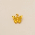 Detailed close-up of a 18K gold butterfly pendant with fine textured wing engravings - Butterfly