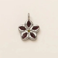 Macro shot of silver floral pendant with red marquise stones and yellow center gem - No.15 Lucky Clover