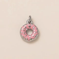 Macro detail of a 18K gold-plated stainless steel donut pendant with pink enamel - Donut