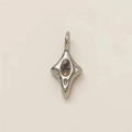 Detailed close-up of a silver fork pendant with a central oval champagne gemstone - No.9 Starburst