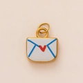 Close-up of a gold envelope pendant with blue outlines and a small red heart detail - Square Envelope Pendant