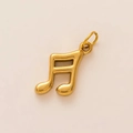 Macro shot of 18K gold plated musical note pendant with polished metallic luster - Gold Musical Note Style