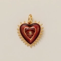 Detailed view of heart-shaped pendant with red enamel eye motif and gold sunburst edges - Heart Pendant