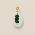 Detailed shot of oval white enamel pendant featuring a green martini olive print with gold ring - Sugar Coated Haws
