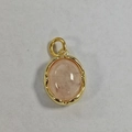Detailed close-up of oval pink quartz stone pendant with gold plated bezel setting - Rose Quartz Oval Pendant