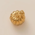 Detailed macro view of a 18K gold polished pumpkin charm with vertical textures - Pumpkin