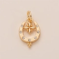 Detail of gold U-shaped pendant with inset zircons and hanging star charm accessory - Horseshoe Pendant