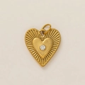 Close-up of golden double-layer heart pendant with sunray texture and zircon stone - Double Heart Eye