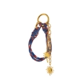Detail of woven rope keychain with gold coconut tree and smiling sun pendants - Purple Sun Bag Charm