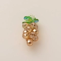 Detailed macro view of a champagne faceted crystal grape pendant with small green leaves - Yellow Grape