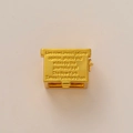 Detail of gold-plated brass newsbox pendant with engraved New York Times typography - New York Times
