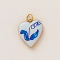 Close-up of heart-shaped 18K gold-plated pendant with blue lily flower enamel detail - Blue Lily of the Valley Heart Style