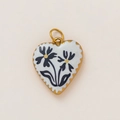Close-up of heart pendant with 18K gold plating and black daisy enamel patterns - Black Daisy Heart Style