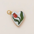 Macro detail of heart-shaped white enamel pendant with red tulip and 18K gold finish - Red Tulip Heart Style