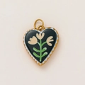 Macro detail of 18K gold-plated heart pendant with floral enamel and wave pattern - Dark Base Floral Heart Style