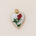 Detailed macro view of heart-shaped white enamel pendant with vintage red rose floral pattern - Red Rose Floral Heart Style