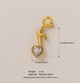 Gold stainless steel musical note pendant with heart-shaped zircon detail on beige background - Musical Note Heart Style