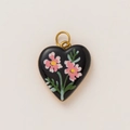Macro detail of heart-shaped black enamel pendant with pink floral motif and 18K gold plating - Black Glaze Pink Floral Heart Style