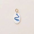 Detail view of oval white flower charm with blue patterns and 18K gold plated ring - No.10 Oval Star Pathway