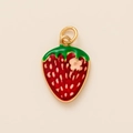 Macro shot of a red strawberry enamel pendant with a gold rim and small white flower - 15mm / Heart Strawberry (No. 7)