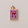 Macro detail of a gold rectangular pendant with purple enamel and a red bow charm - Square Purple Bowknot Style (MQPK254807S)