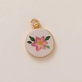 Detail view of a round gold-plated pendant featuring hand-painted pink flowers and green leaves - 15 Small Flowers