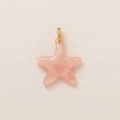 Macro shot of a pink star pendant with gold-plated bail and sparkling zircon stones - Starfish Pendant