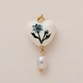 Detail of heart ceramic pendant with blue flower pattern and white baroque pearl drop - April Birth Flower Heart Pendant