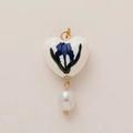 Detail of heart ceramic pendant with blue iris pattern and white teardrop pearl - February Birth Flower Heart Pendant