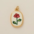 Detailed close-up of 18k gold plated oval pendant with red rose enamel floral design - November Flower Pendant / 1 Piece
