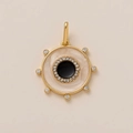 Detailed view of sun-inspired gold pendant with black enamel center and zircon stones - Round