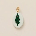 Close-up of ceramic oval pendant with green and red floral print and gold metal loop - Olive Pendant