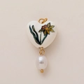 Detail of heart ceramic pendant with narcissus flower and irregular pearl drop - March Birth Flower Heart Pendant